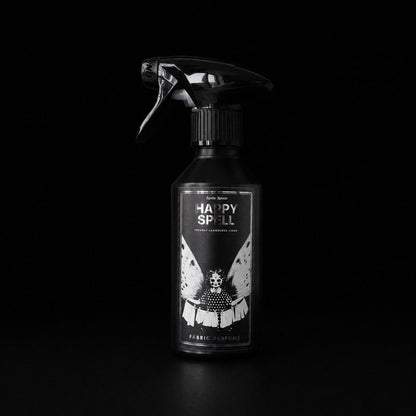 Happy Spell 250ml linen and fabric spray by Apollo Ipsum on a black studio background