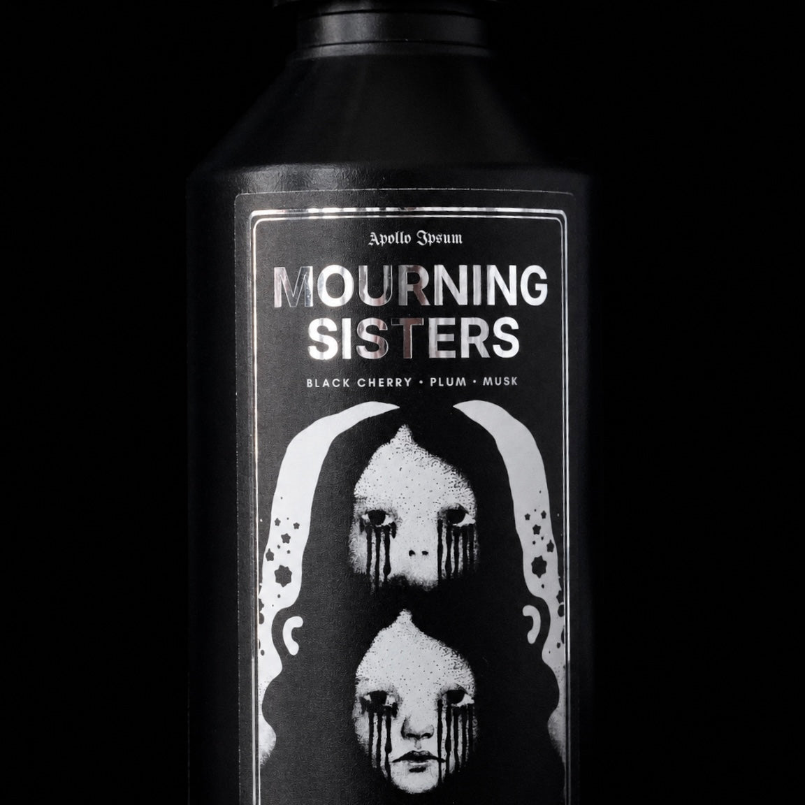 Close-up of the Mourning Sisters Fabric Perfume label on a dark fruity home fragrance spray