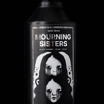 Close-up of the Mourning Sisters Fabric Perfume label on a dark fruity home fragrance spray