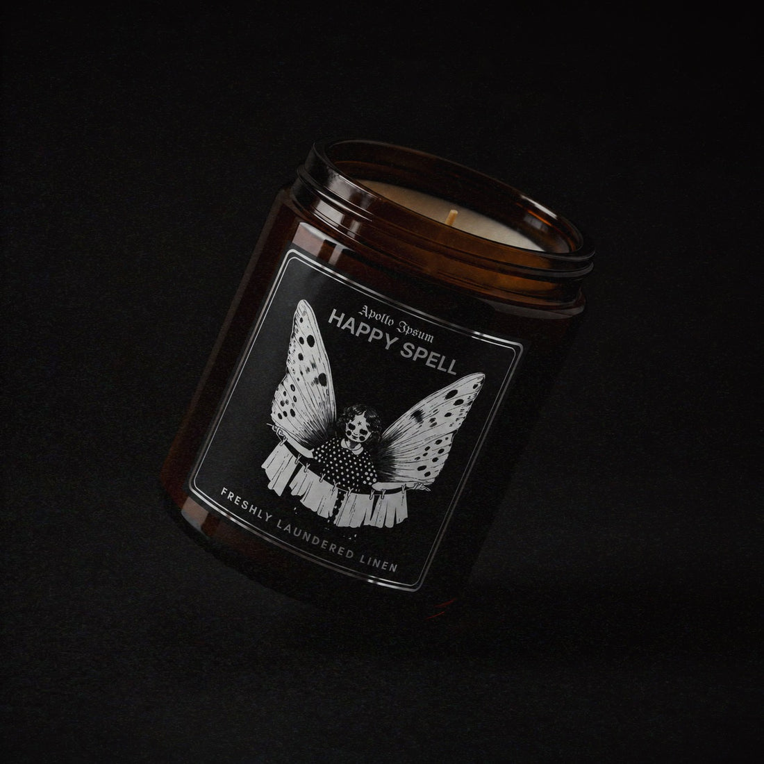 Happy Spell soy wax candle in an amber jar with illustrated label, Apollo Ipsum Things That Shouldn&