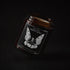 Happy Spell soy wax candle in an amber jar with illustrated label, Apollo Ipsum Things That Shouldn&