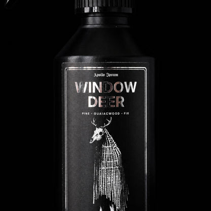 Close-up of the Window Deer Fabric Perfume label on a woody home fragrance spray