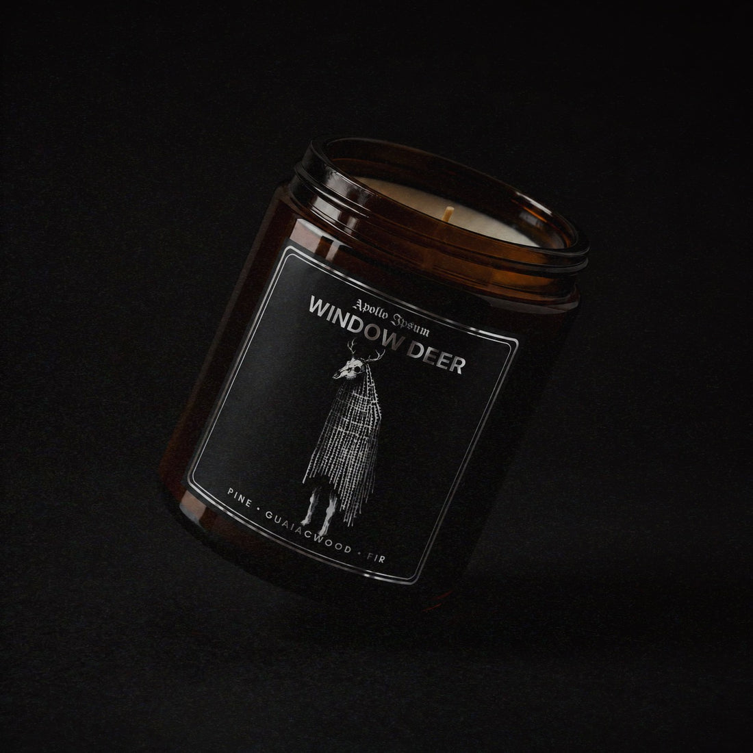 Window Deer soy wax candle in an amber jar with illustrated label, Apollo Ipsum Things That Shouldn&